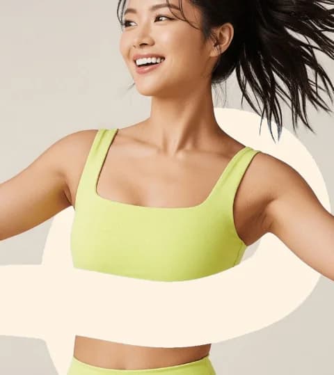 Smiling club member dancing in a lime sports top